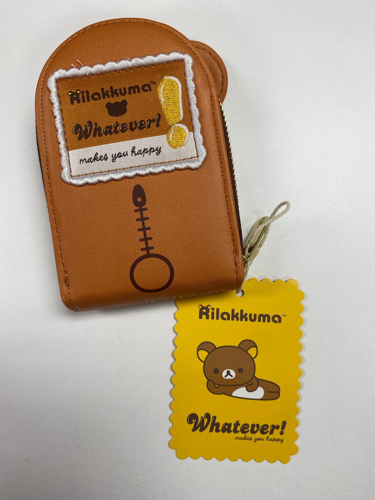 Original back photo of Rilakkuma Card Wallet showing the embroidered patch and yellow paper tag
