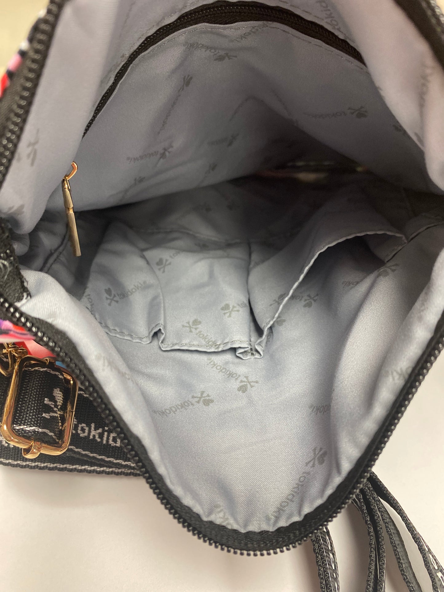 Original interior look of the tokidoki bag with grey branding lining
