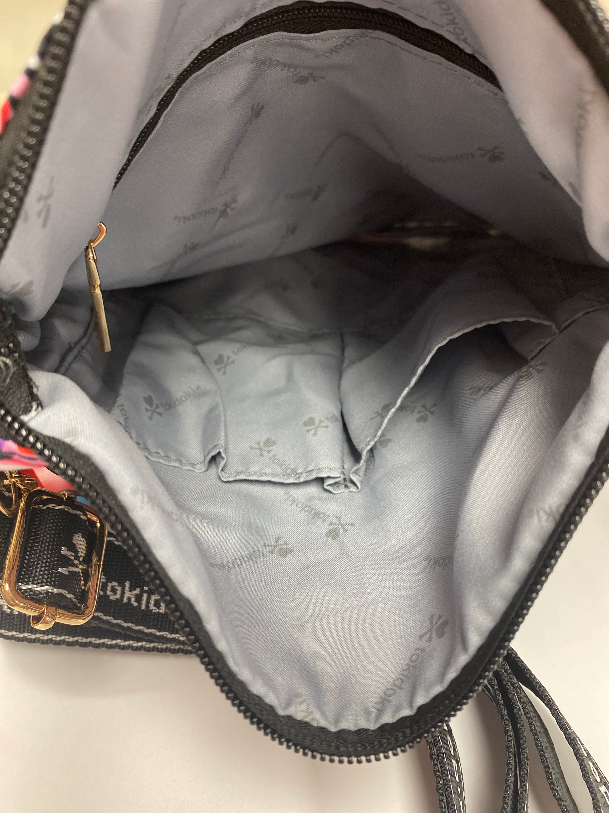Original interior look of the tokidoki bag with grey branding lining