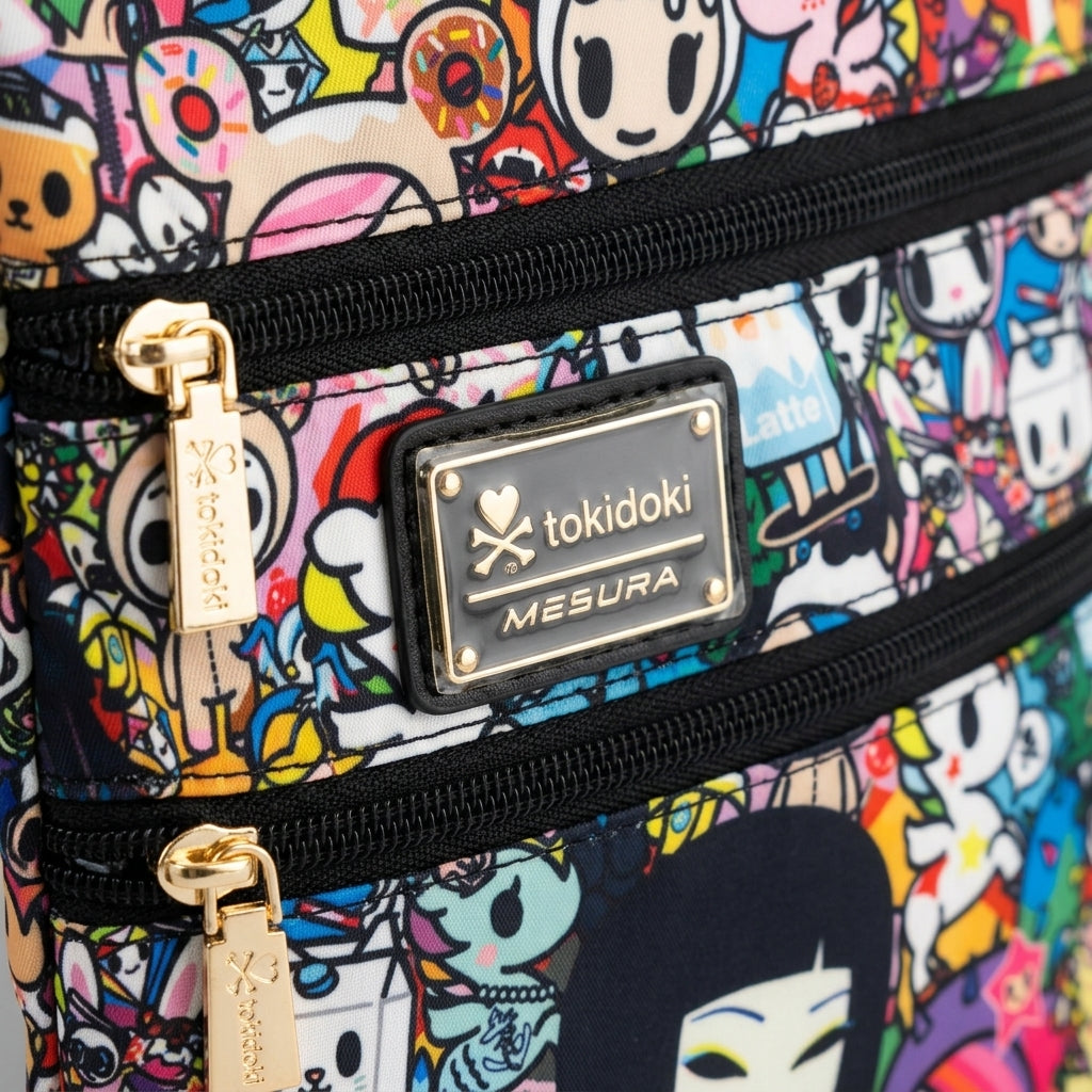 Close-up shot of gold-toned zippers and brand plaque on the tokidoki bag