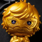 Macro close-up highlighting the metallic gold finish and detailed eyes of the Joker chibi figure