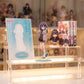 Kurumi Haraga Acrylic Stand displayed on a multi-tier collector's shelf with anime merch